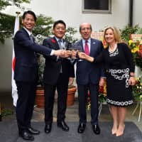 Gonzalo de Benito (second from right), Spanish ambassador to Japan, and his wife, Esther (right), raise a toast with Kenji Yamada (left), parliamentary vice-minister for foreign affairs, and Takuya Hirai (second from left), minister in charge of science and technology policies, during a reception to celebrate the national day of Spain on Oct. 12. | YOSHIAKI MIURA