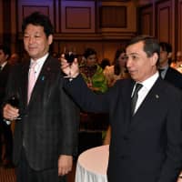 Gurban Elyasov (right), Turkmenistan ambassador to Japan, joins Kentaro Sonoura (left), a member of the House of Representatives and special adviser to the prime minister, during a reception to celebrate the 27th anniversary of Turkmenistan independence at the Imperial Hotel, Tokyo on Oct. 12. | YOSHIAKI MIURA