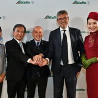 Fabio Lazzerini (second from right), chief commercial officer of Alitalia, poses with Shuichi Fujimura (second from left), executive vice president of international affairs for All Nippon Airways Co., Ltd., and Giorgio Starace (center), Italian ambassador to Japan, during a reception at the Italian Embassy on Oct. 15. Starting on Oct. 28, the two carriers began codeshare operations on Japan-Italy and domestic routes. | YOSHIAKI MIURA
