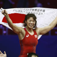 Risako Kawai celebrates after her 8-0 victory over Turkey\'s Elif Yesilirma in the women\'s 59-kg freestyle final at the World Wrestling Championships on Tuesday in Budapest. Kawai didn\'t surrender a single point over the last week at Papp Laszlo Arena. Mayu Mukaida also won gold for Japan, claiming the title in the women\'s 55-kg freestyle division. | KYODO