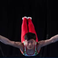 Osaka native Takeru Kitazono, 15, performs on the rings before capturing gold in the men\'s all-around artistic gymnastics final at the 2018 Summer Youth Olympics in Buenos Aires on Thursday. It was Japan\'s fifth gold and 14th overall medal of the competition. | REUTERS