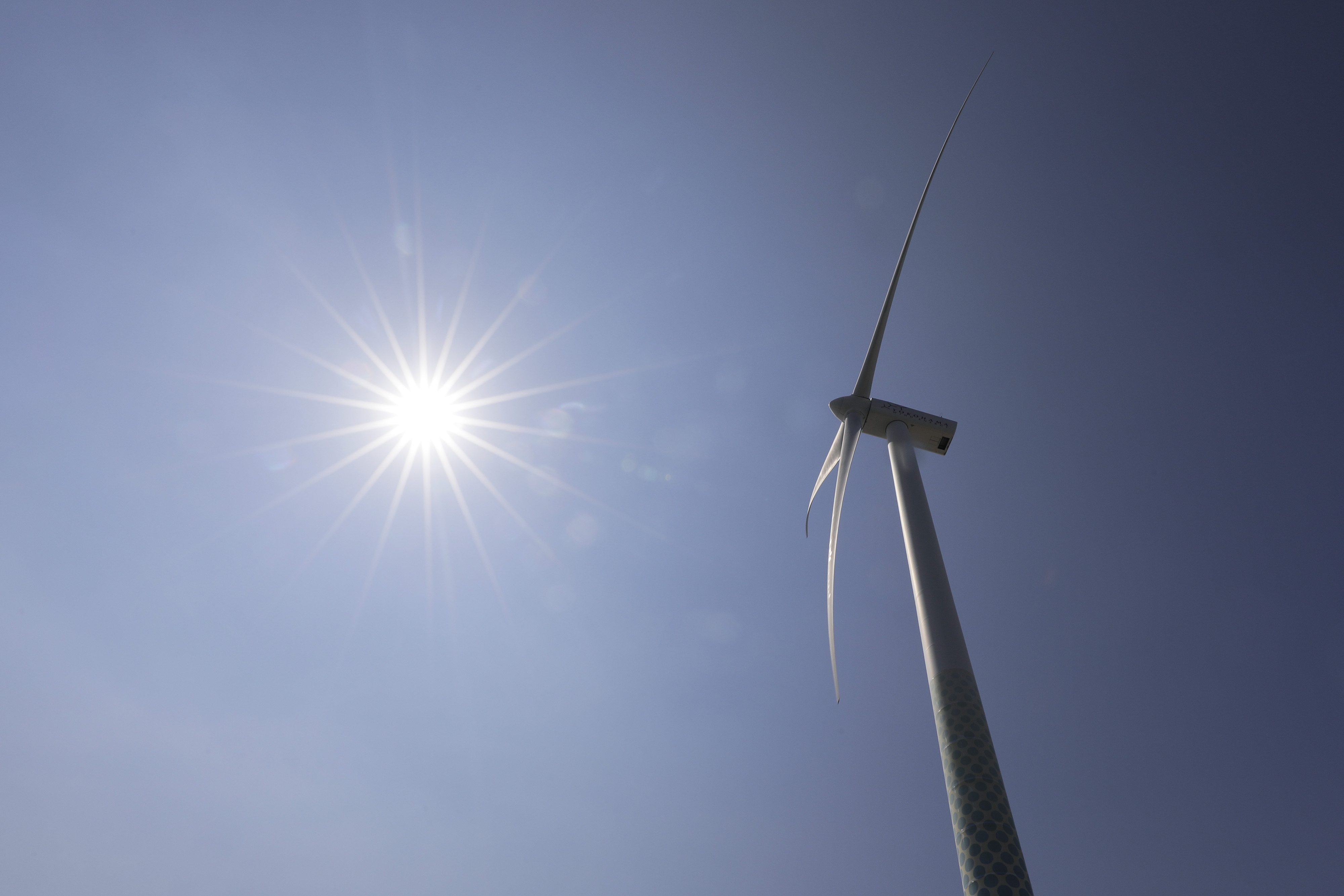 A wind turbine operates at the Yokohama City Wind Power Plant, also known as Hama Wing, last year. Japan accounted for 3 percent of global greenhouse gas emissions last year. | KIYOSHI OTA / BLOOMBERG