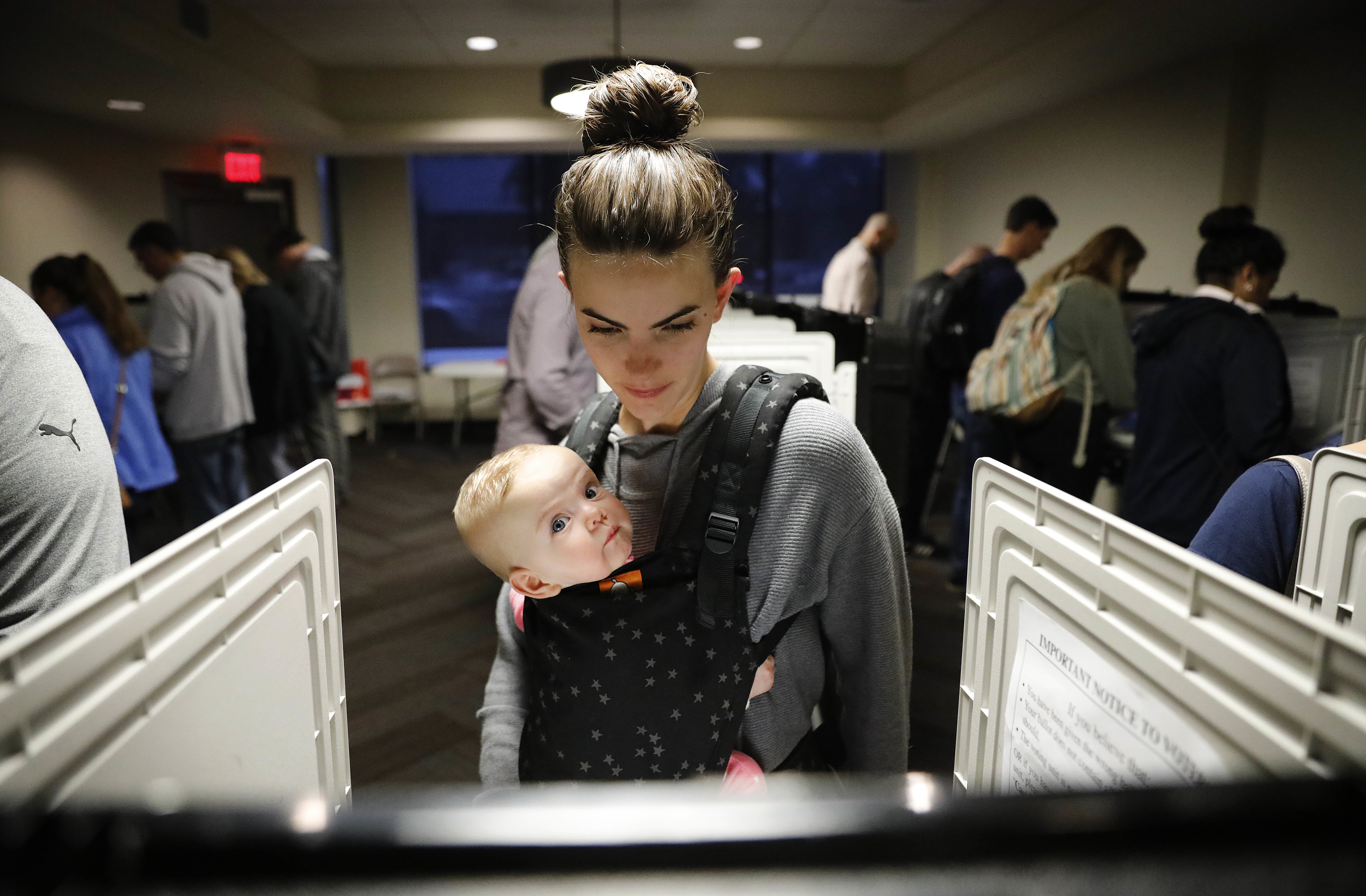 Kristen Leach votes with her 6-month-old daughter, Nora, on Election Day in Atlanta.