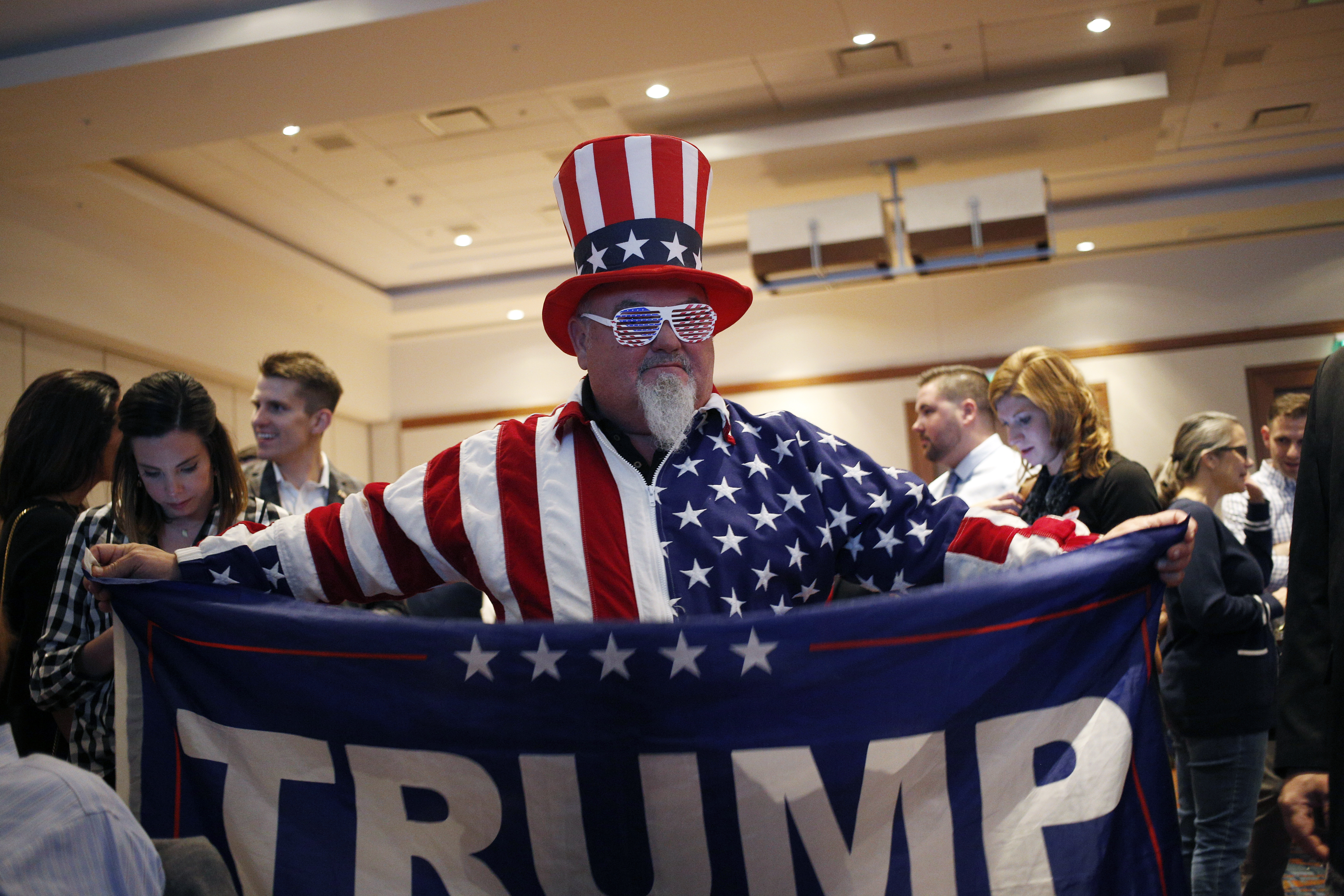 An attendee dressed as Uncle Sam holds a flag in support of U.S. President Donald Trump during an election night rally for Senator-elect Mike Braun, a Republican from Indiana, in Indianapolis on Tuesday.