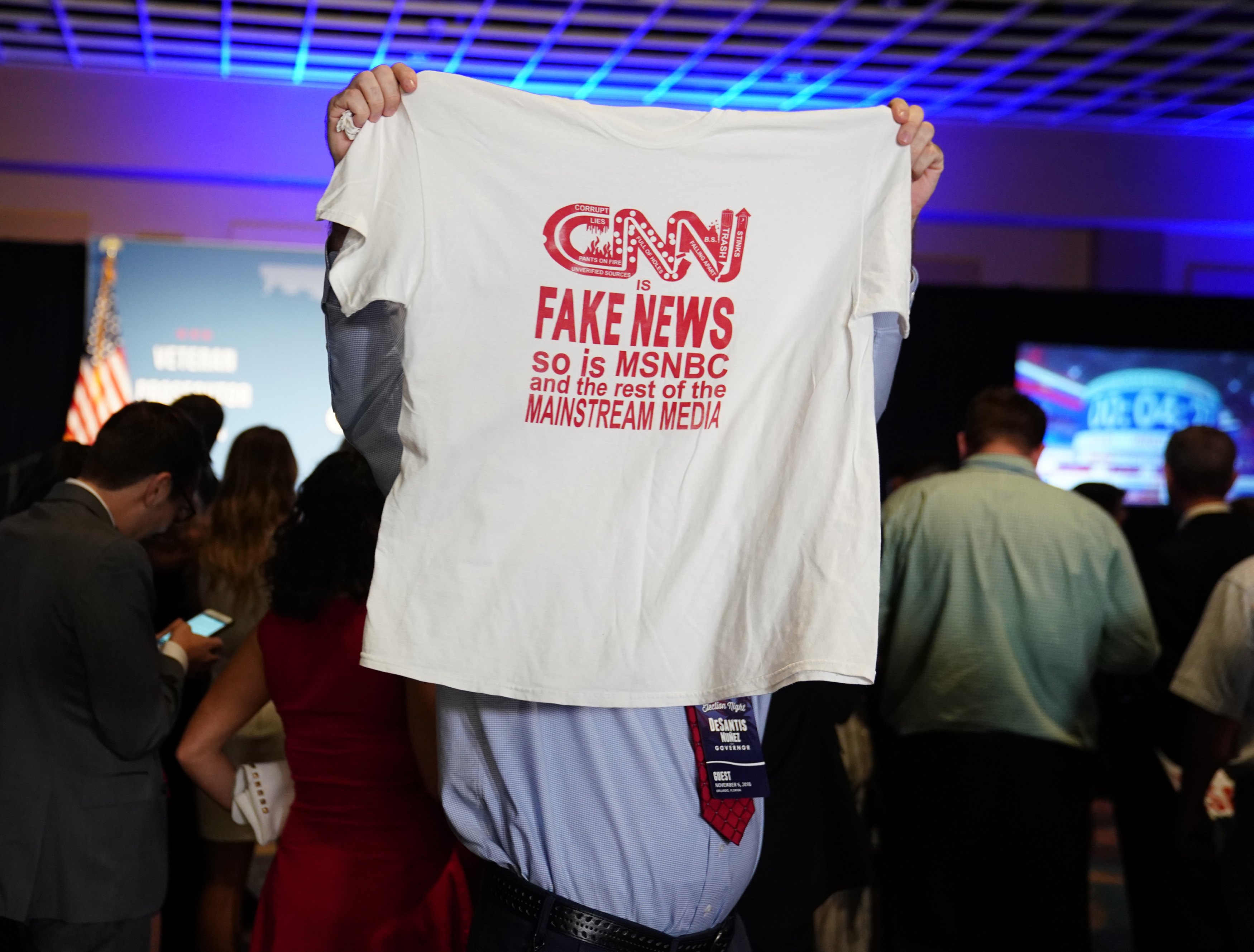 A man holds up a T-shirt at the midterm election night party for Republican gubernatorial candidate Ron DeSantis in Orlando, Florida, on Tuesday. DeSantis won his contest. 