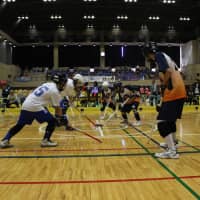 Participants play floor hockey during a national competition that was sponsored by FP Corp. in Katsushika Ward, Tokyo, on Oct. 20. | FP CORP.