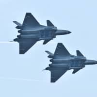 Chengdu J-20 stealth fighter jets of Chinese People\'s Liberation Army (PLA) Air Force perform with open weapon bays during the China International Aviation and Aerospace Exhibition, or Zhuhai Airshow, in Zhuhai, Guangdong province, China, Sunday. | REUTERS