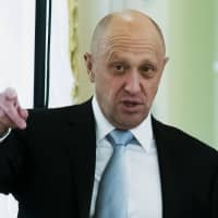 Businessman Yevgeny Prigozhin gestures as he attends a summit meeting between Russian President Vladimir Putin and Turkish President Recep Tayyip Erdogan at the Konstantin palace outside St. Petersburg, Russia, in 2016. | AP