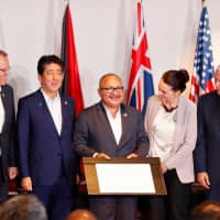 Papua New Guinea Prime Minister Peter O\' Neill (center) stands with Australian Prime Minister Scott Morrison (left), Prime Minister Shinzo Abe (second left), New Zealand Prime Minister Jacinda Ardern (second right) and U.S. Vice President Mike Pence (right) for a photo during the signing of a joint electricity deal between the five nations, during the APEC Summit in Port Moresby on Sunday. | REUTERS