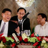 Chinese leader Xi Jinping speaks as Philippine President Rodrigo Duterte listens during a State Banquet at the Malacanang presidential palace in Manila on Tuesday. | REUTERS