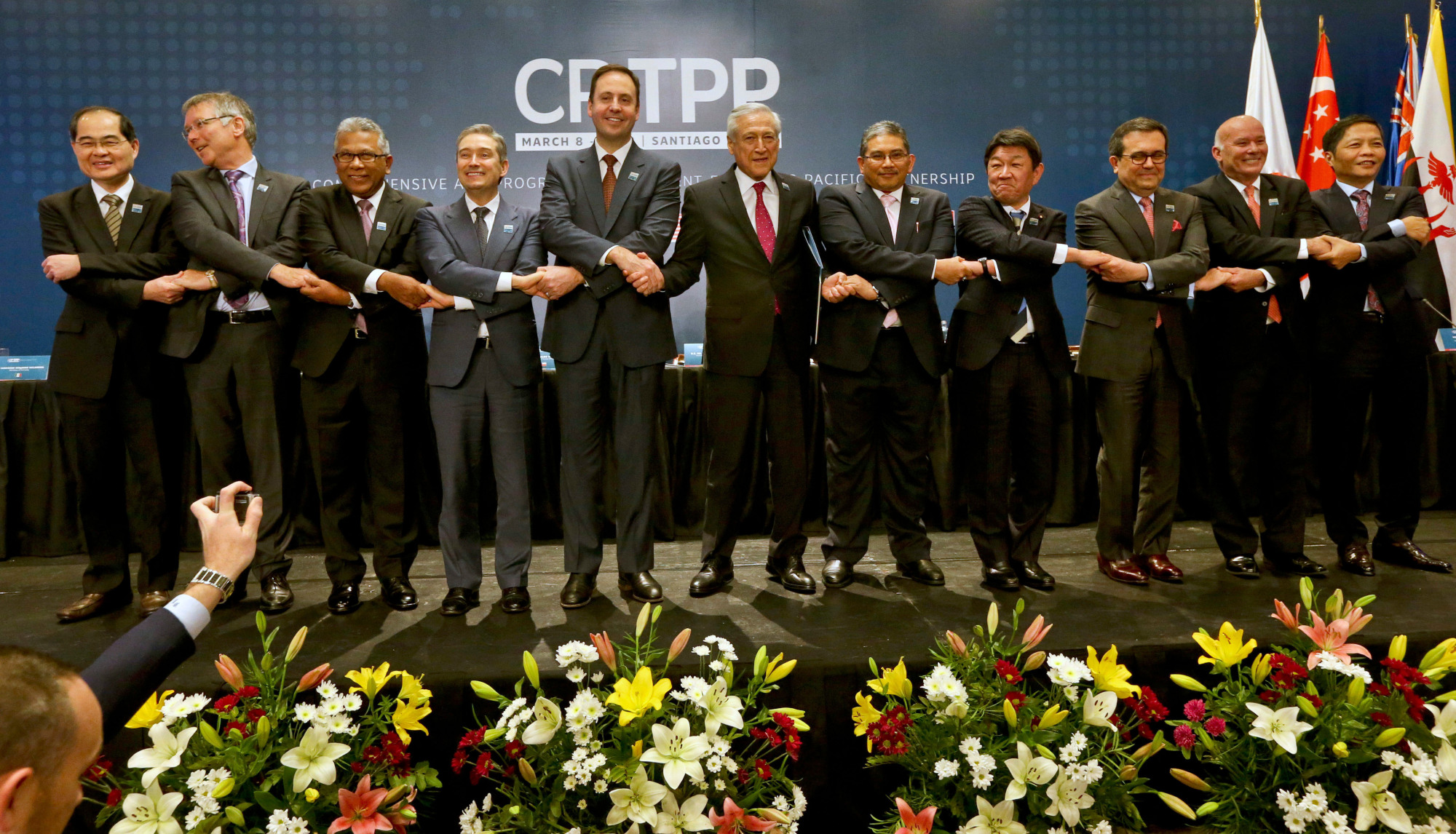 Trade ministers from 11 countries, including Toshimitsu Motegi of Japan (fourth from right), pose for pictures after the signing ceremony for the Comprehensive and Progressive Agreement for Trans-Pacific Partnership, in Santiago, Chile, on March 8. | AP