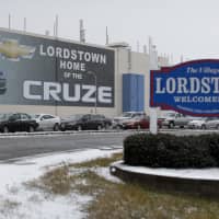 A banner depicting the Chevrolet Cruze model vehicle is displayed at the General Motors Lordstown plant, Tuesday in Lordstown, Ohio. Even though unemployment is low, the economy is growing and U.S. auto sales are near historic highs, GM is cutting thousands of jobs in a major restructuring aimed at generating cash to spend on innovation. GM put five plants up for possible closure, including the plant in Lordstown. | AP