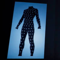 Zozo CEO Yusaku Maezawa introduces the Zozosuit at an event in Tokyo in July. | REUTERS