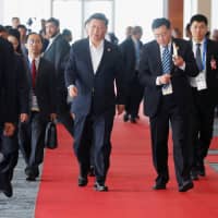Chinese President Xi Jinping leaves APEC Haus during the APEC summit in Port Moresby on Sunday. | REUTERS