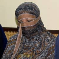 Asia Bibi, a Pakistani Christian woman, listens to officials at a prison in Sheikhupura near Lahore, Pakistan, in 2010. Italy is working to help relocate the family of Bibi, who was acquitted eight years after being sentenced to death for blasphemy, amid warnings from her husband that their life is in danger in Pakistan. | AP