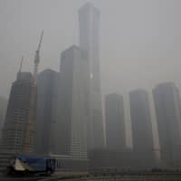 Buildings are seen amid heavy smog in Beijing\'s central business area on Monday. | REUTERS