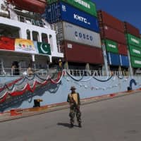 A Pakistan soldier stands guard while a loaded Chinese ship prepares to depart, at Gwadar port, Pakistan, in November 2016. The assault on the consulate in Karachi on Friday was the latest in a series of attacks on China\'s growing influence in Pakistan, where Beijing is financing tens of billions of dollars\' worth of mega-projects that critics fear will plunder the country\'s resources and leave it with crippling debt. | AP