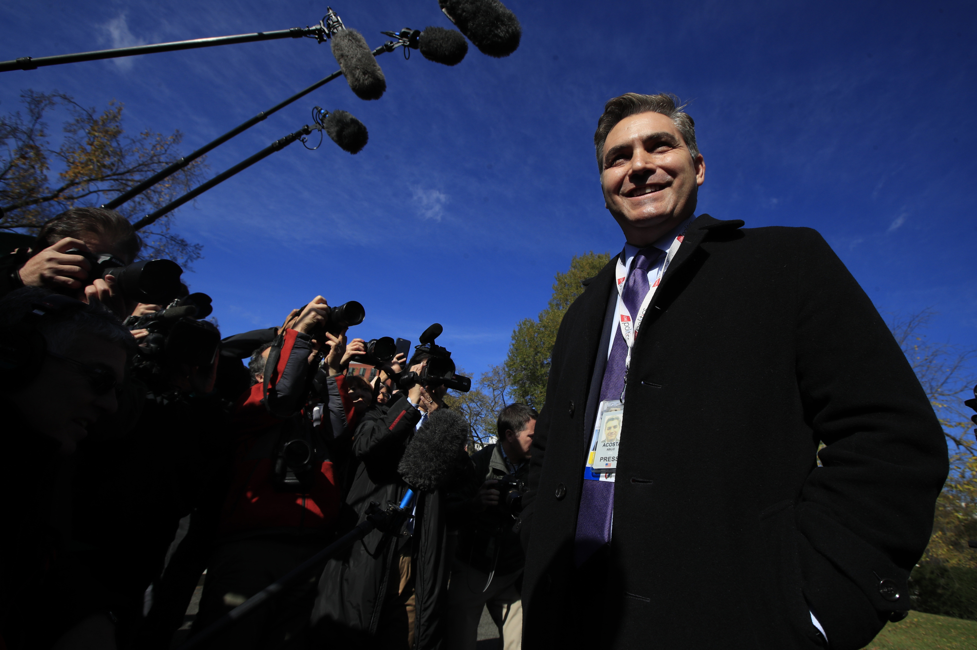 CNN's Jim Acosta speaks to journalists on the North Lawn upon returning to the White House in Washington on Friday. | AP