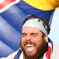 Swimmer Ross Edgley reacts after completing his round-Britain swim, on Margate beach, Britain, Sunday. | REUTERS