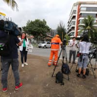 Journalists work in front of the condo of Brazil\'s new president-elect, Jair Bolsonaro,in Rio de Janeiro Oct. 29. | REUTERS