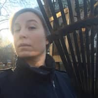 A woman poses with a rake following President Donald Trump\'s comments praising Finland for managing its vast forests by raking, in Turku, Finland, Sunday in this image obtained from social media Monday. | MEIRA PAPPI / VIA REUTERS