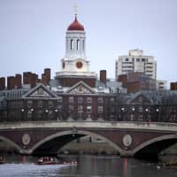 Rowers practice on the Charles River, past the campus of Harvard University in Cambridge, Massachusetts, in March 2017. | AP