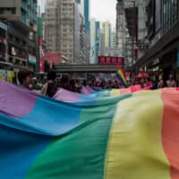 Participants hold a large rainbow flag as they take part in the annual Pride parade at Victoria Park in Hong Kong last Saturday. | AFP-JIJI