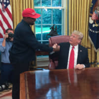 President Donald Trump meets with rapper Kanye West in the Oval Office on Oct. 11. | AFP-JIJI