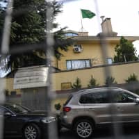 The Saudi Arabia flag flies on the top of the consulate as diplomatic vehicles wait outside the Saudi Consulate on Thursday in Istanbul. Journalist Jamal Khashoggi was strangled as soon as he entered the consulate and his body was dismembered and destroyed as part of a premeditated plan, Turkey\'s chief prosecutor said on Wednesday, making details of the murder public for the first time. | AFP-JIJI