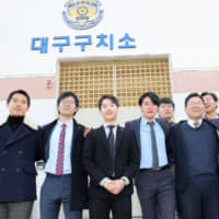 South Korean conscientious objectors pose for photographs after being released from Daegu detention center in Daegu, South Korea, on Friday. | REUTERS