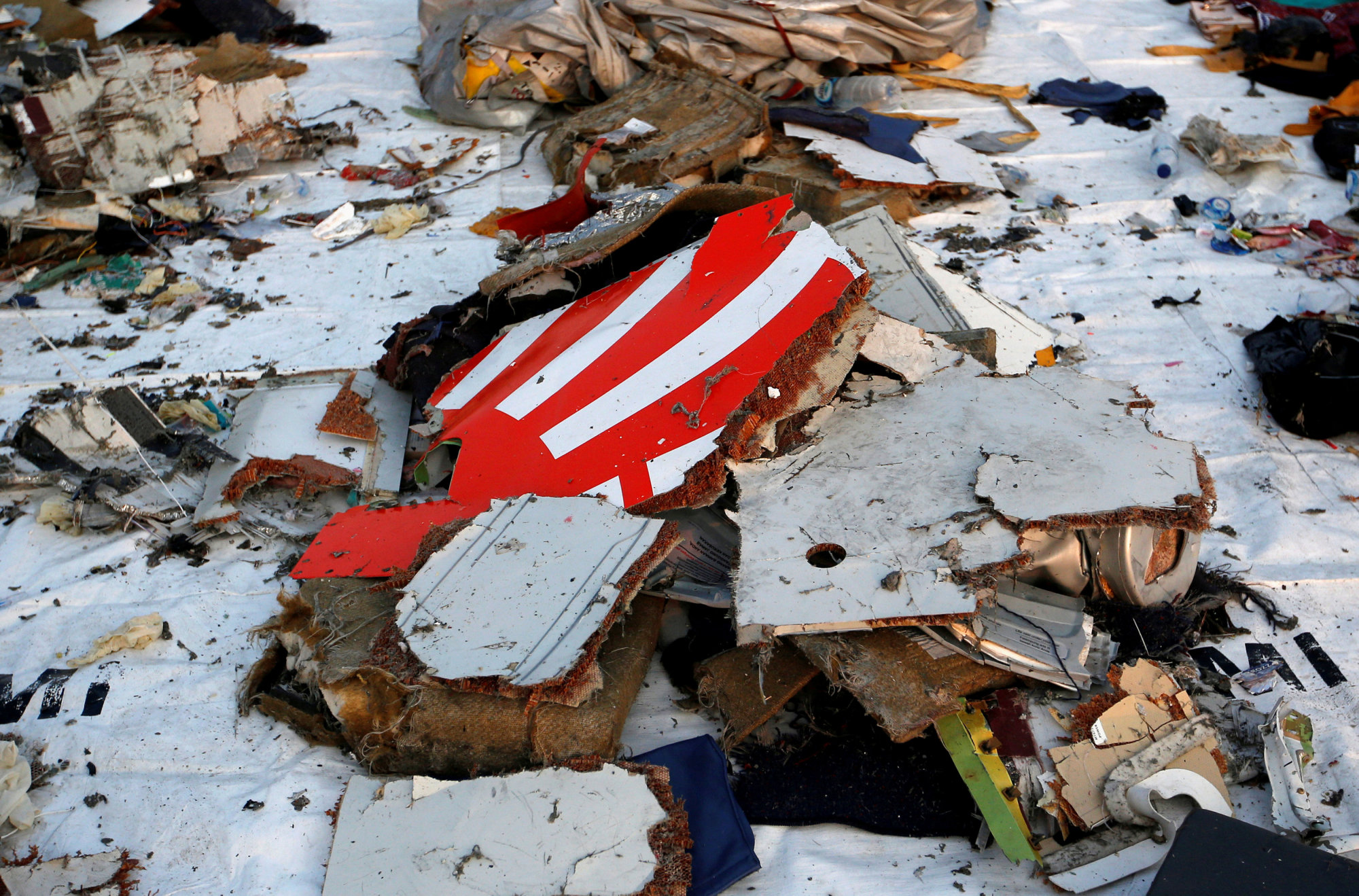 Wreckage recovered from Lion Air flight JT610, which crashed into the sea, lies at Tanjung Priok port in Jakarta pm on Oct. 29. | REUTERS
