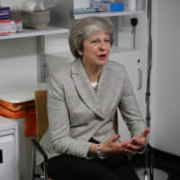Britain\'s Prime Minister Theresa May visits the Kentish Town Health Centre in London on Thursday. | POOL / VIA REUTERS