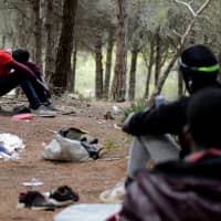 African migrants are seen in their hiding place in the Moroccan mountains near the port city of Tangier in September. | REUTERS