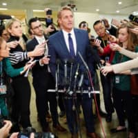 Republican Senator Jeff Flake speaks to reporters at the U.S. Capitol in Washington on Wednesday. | AFP-JIJI