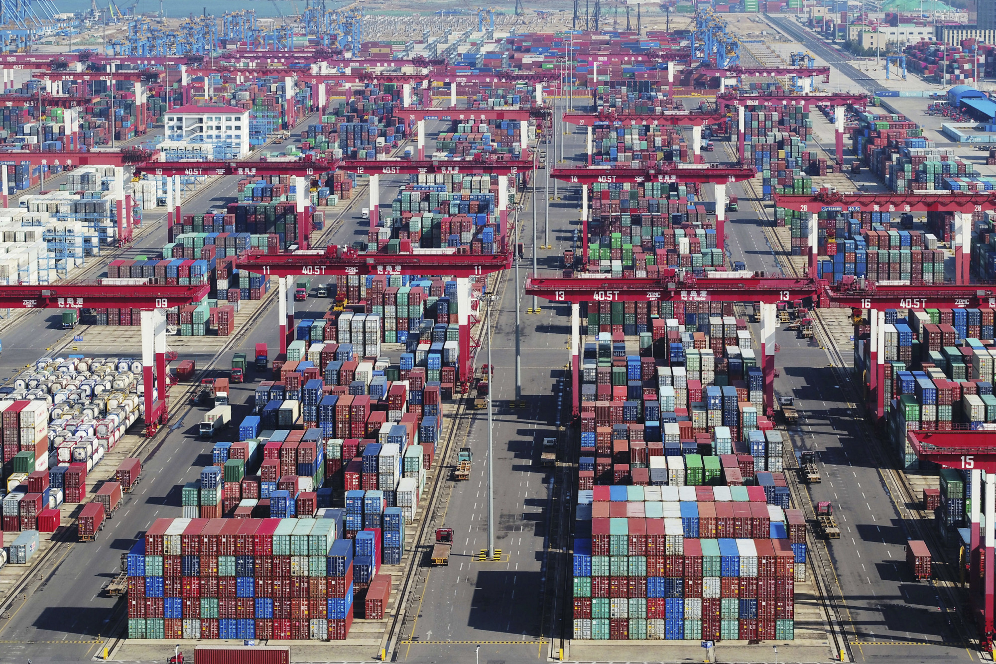 Containers are piled high at a port in Qingdao in eastern China's Shandong province on Thursday. | CHINATOPIX / VIA AP