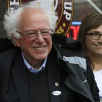 U.S. Sen. Bernie Sanders, I-Vt., left, smiles as he poses for a photograph with Vermont Democratic gubernatorial candidate Christine Hallquist outside City Hall in Saint Albans, Vermont, Tuesday. | AP
