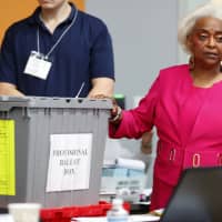 Broward County Supervisor of Elections Brenda Snipes (right) shows a ballot box that was found in a rental car after the elections and turned out to only contain election day supplies, as election employees sort ballots and prepare to count them Monday in Lauderhill, Florida. | AP