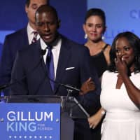 Democratic Florida gubernatorial candidate and Tallahassee Mayor Andrew Gillum concedes the Florida governor\'s race to U.S. Rep. Ron DeSantis as Gillum\'s wife, R. Jai, wipes away tears and his running mate Chris King and King\'s wife, Kristin, look on at his midterm election night rally in Tallahassee on Tuesday. | REUTERS
