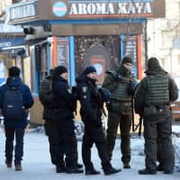 Servicemen of the Ukrainian National Guard patrol in the center of Kiev on Friday, after martial law was imposed in border regions. | AFP-JIJI