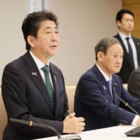 In Tokyo on Tuesday, Prime Minister Shinzo Abe speaks at a government committee meeting regarding ceremony arrangements for the ascension of the new Emperor. | KYODO