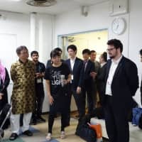 Officials from information technology firms in Miyazaki Prefecture, together with people involved in the B-JET program, take part in a welcoming ceremony for newly arrived Bangladeshi engineers in the city of Miyazaki on Oct. 12. | KAZUAKI NAGATA