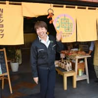 Yumi Someya, president of Tokyo Yu Denryoku and U\'s Corp., which collect used cooking oil to generate electricity, is all smiles at a cafe in Tokyo\'s Sumida Ward on Oct. 22. The cafe, run by Tokyo Yu Denryoku, uses power generated by the companies. | SATOKO KAWASAKI