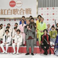 Issa (front row, third from right), lead singer of Da Pump, speaks Wednesday at a news conference held at NHK in Tokyo, where the public broadcaster announced the lineup for its annual New Year\'s Eve live music program. | KYODO