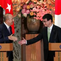 Foreign Minister Taro Kono and his Turkish counterpart, Mevlut Cavusoglu, hold a news conference in Tokyo on Monday. | REUTERS