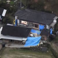 An aerial photo taken Monday shows a house in Miyazaki Prefecture where six bodies, including that of a young girl, were discovered. | KYODO