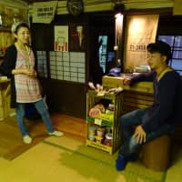 Naoko Ida and her husband, Takayuki, who have lived in the western Tokyo town of Okutama for several years, explain the features of the teahouse they opened last year during an interview in September. | SARAH SUK
