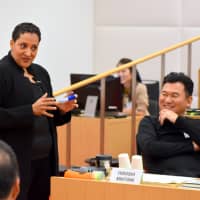 Hiroshi Mikitani, CEO of Rakuten Inc., listens to a lecture by Tsedal Neeley , a professor at Harvard Business School, in Tokyo on Oct. 24. | SATOKO KAWASAKI