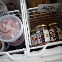 Shiokara products, made from a traditional fermented squid dish, are pictured inside a freezer at a factory owned by Takashi Odajima in Hakodate, Hokkaido, on July 19. | REUTERS