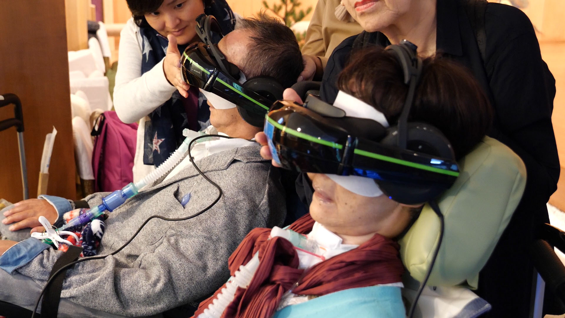 Tour participants with ALS experience inaccessible landmarks using virtual reality headsets on Oct. 14.
