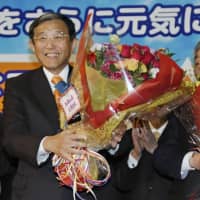 Yoshinobu Nisaka poses for a photo in the city of Wakayama on Sunday evening after securing a fourth consecutive term as governor of Wakayama Prefecture. | KYODO